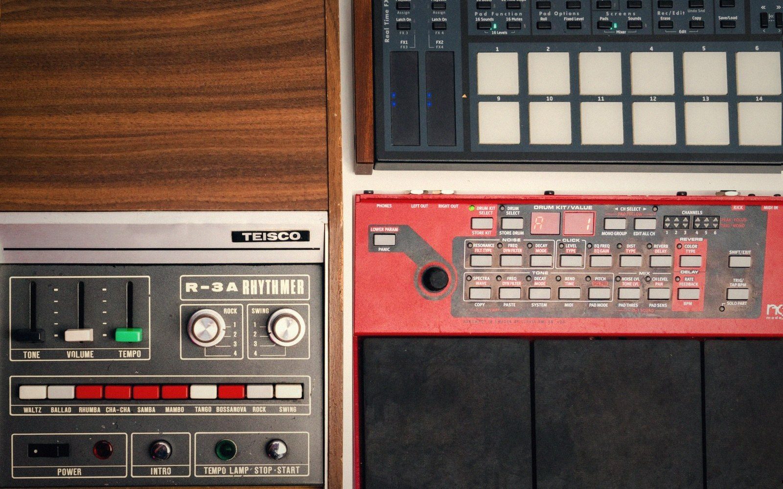 A vintage drum machine on a worn wooden surface, close-cropped, pad buttons and display visible